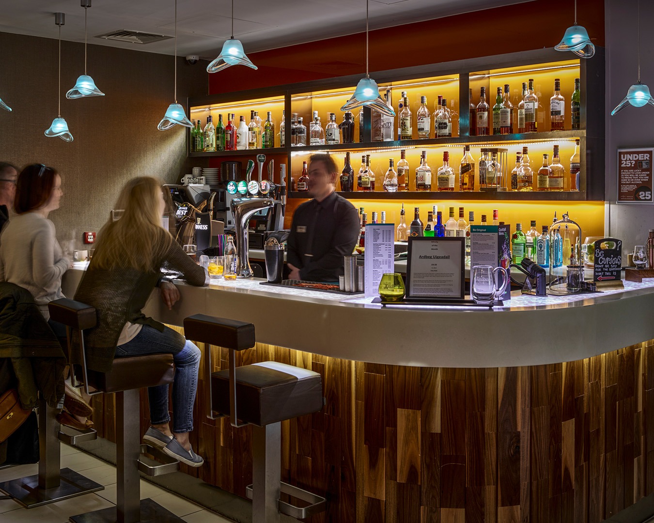 People drinking in a bar at Hotel Indigo Edinburgh