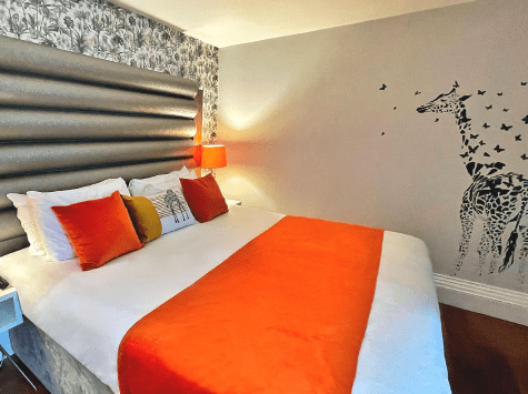 Room with orange giraffe decor.
